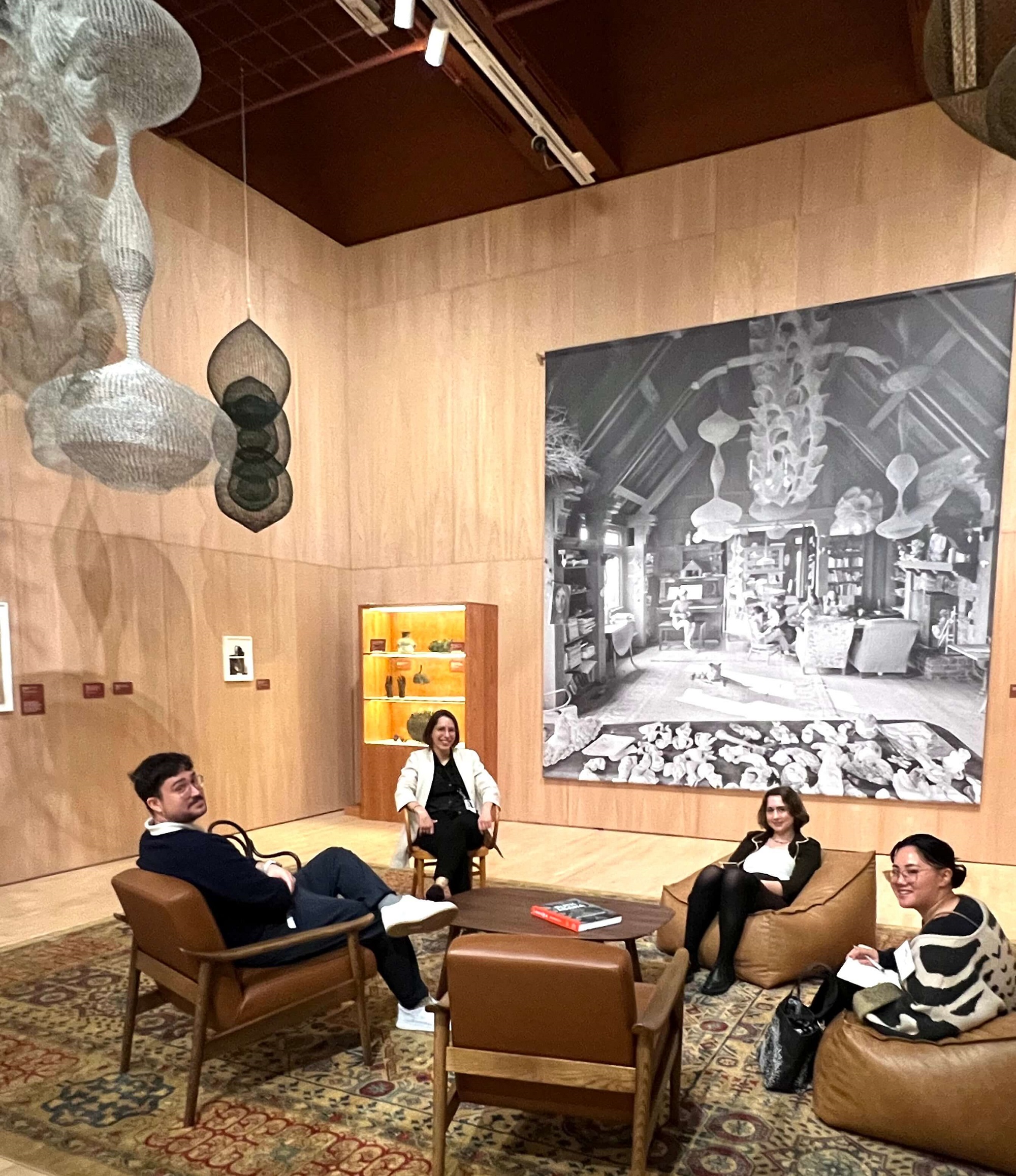 Installation View of the Asawa "Living Room" with SFMOMA Staff. Ruth Asawa: Retrospective. SFMOMA, SF.
